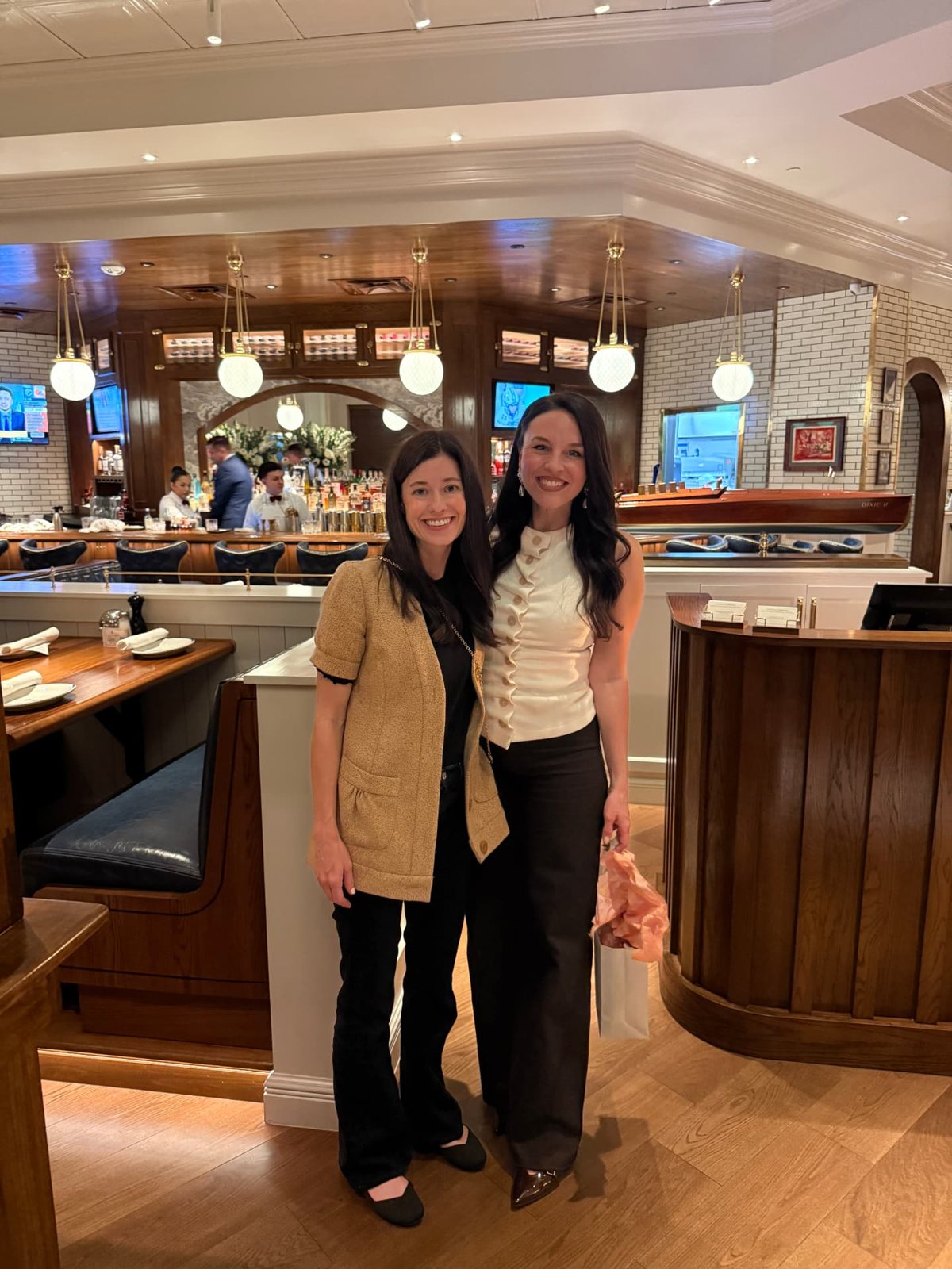 Alyssa and Lori standing in the bright dining room at Hudson House Southlake