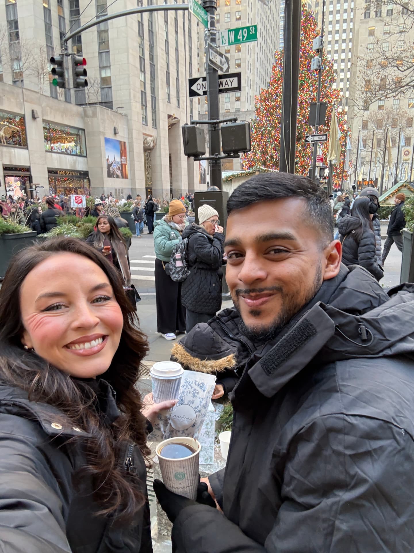 Alyssa and Hector Hidalgo holding Maman coffee near Rockefeller Center at Christmas in New York City