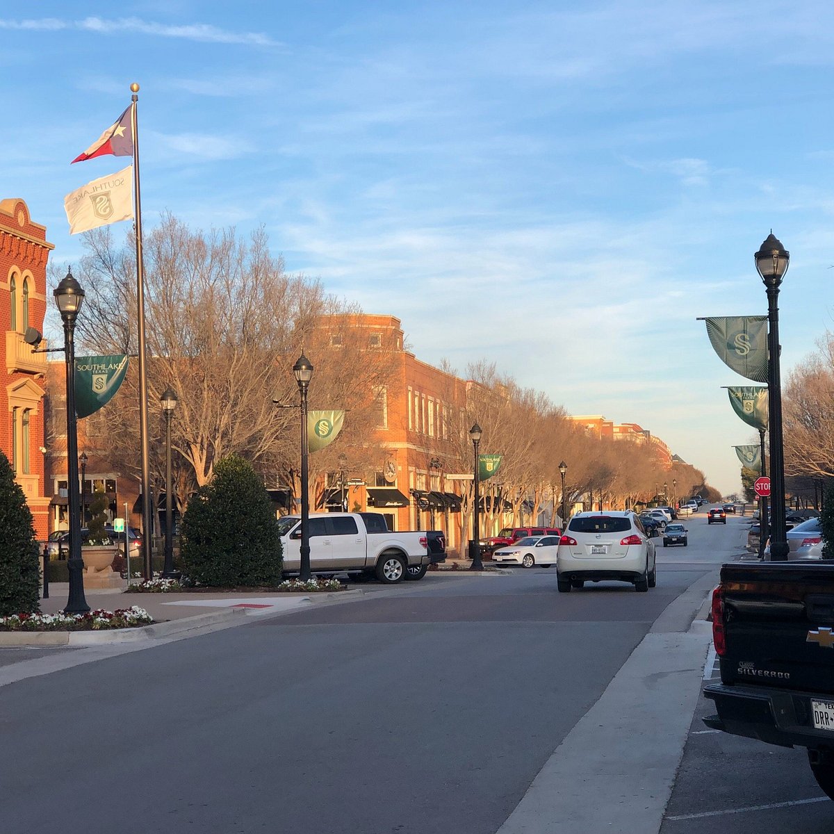 Street lined with shops and Southlake banners in Southlake Town Square