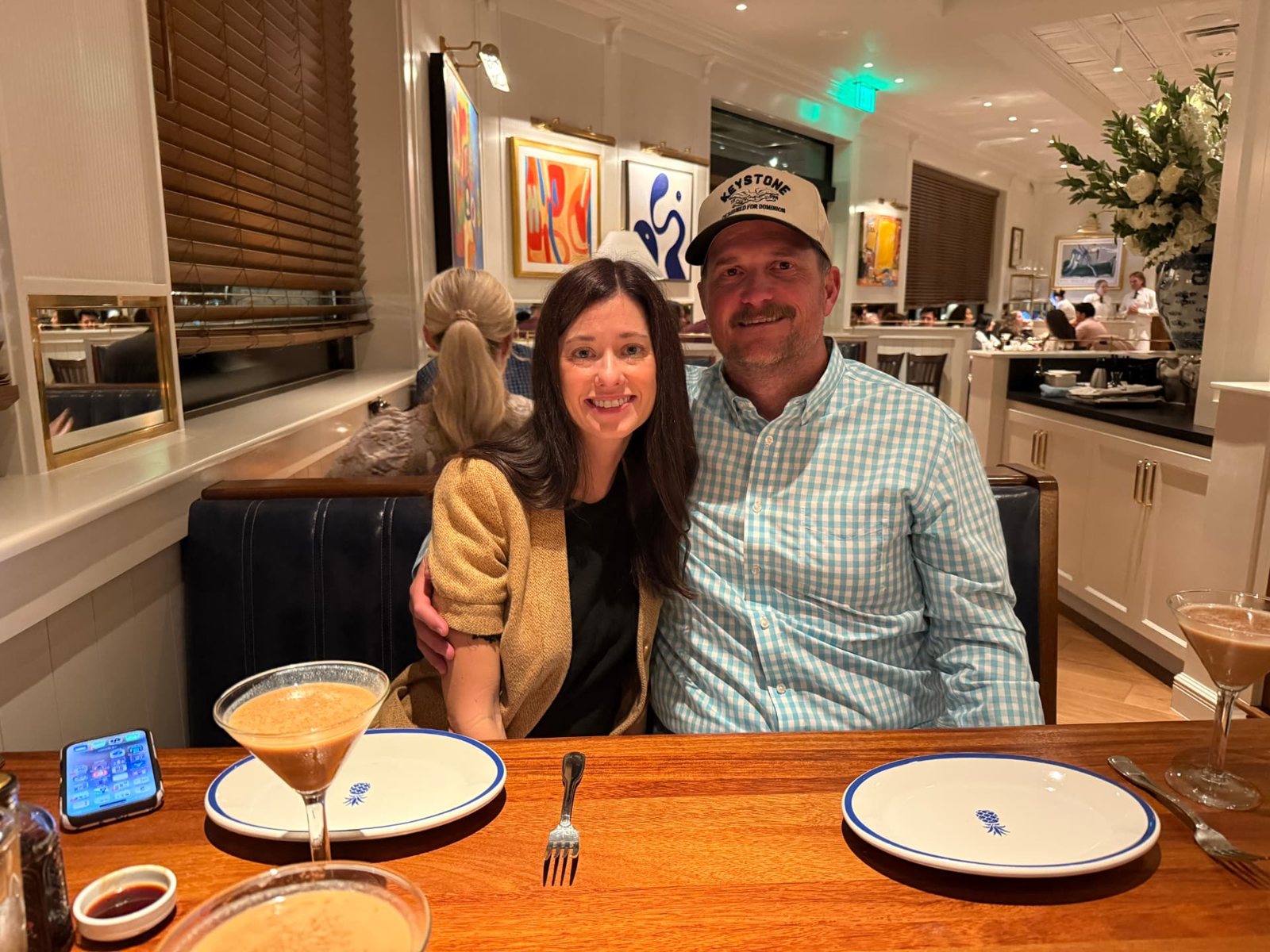 Brad and Lori seated at a table in Hudson House Southlake with espresso martinis